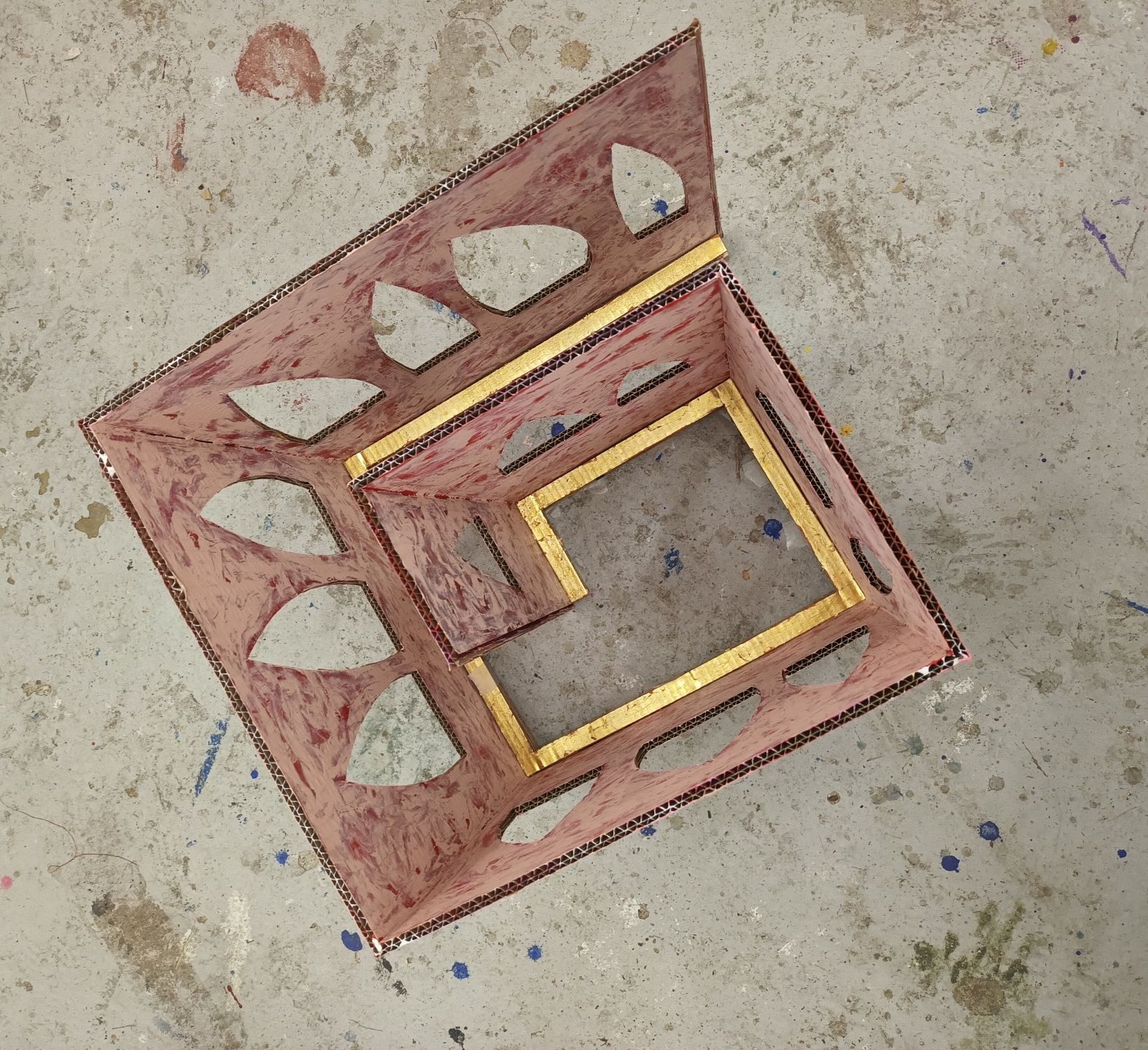 Aerial view of unfinished cardboard sculpture- painted pink and gold