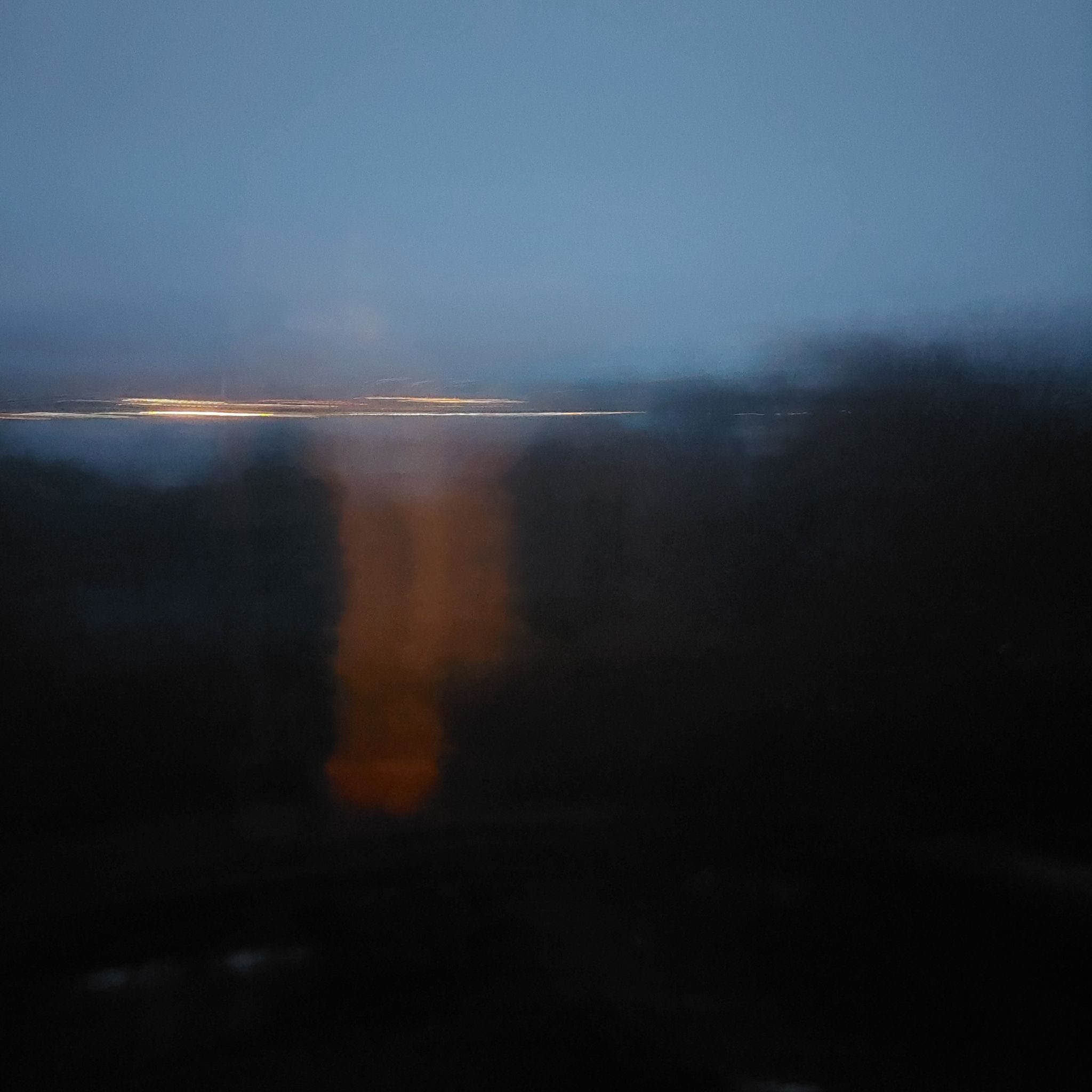 A photographic study in atmospheric depth and value extremes. The piece functions through omission rather than intervention. The warm, vertical glow acts as a soft anchor against sharp, horizontal streaks of light.