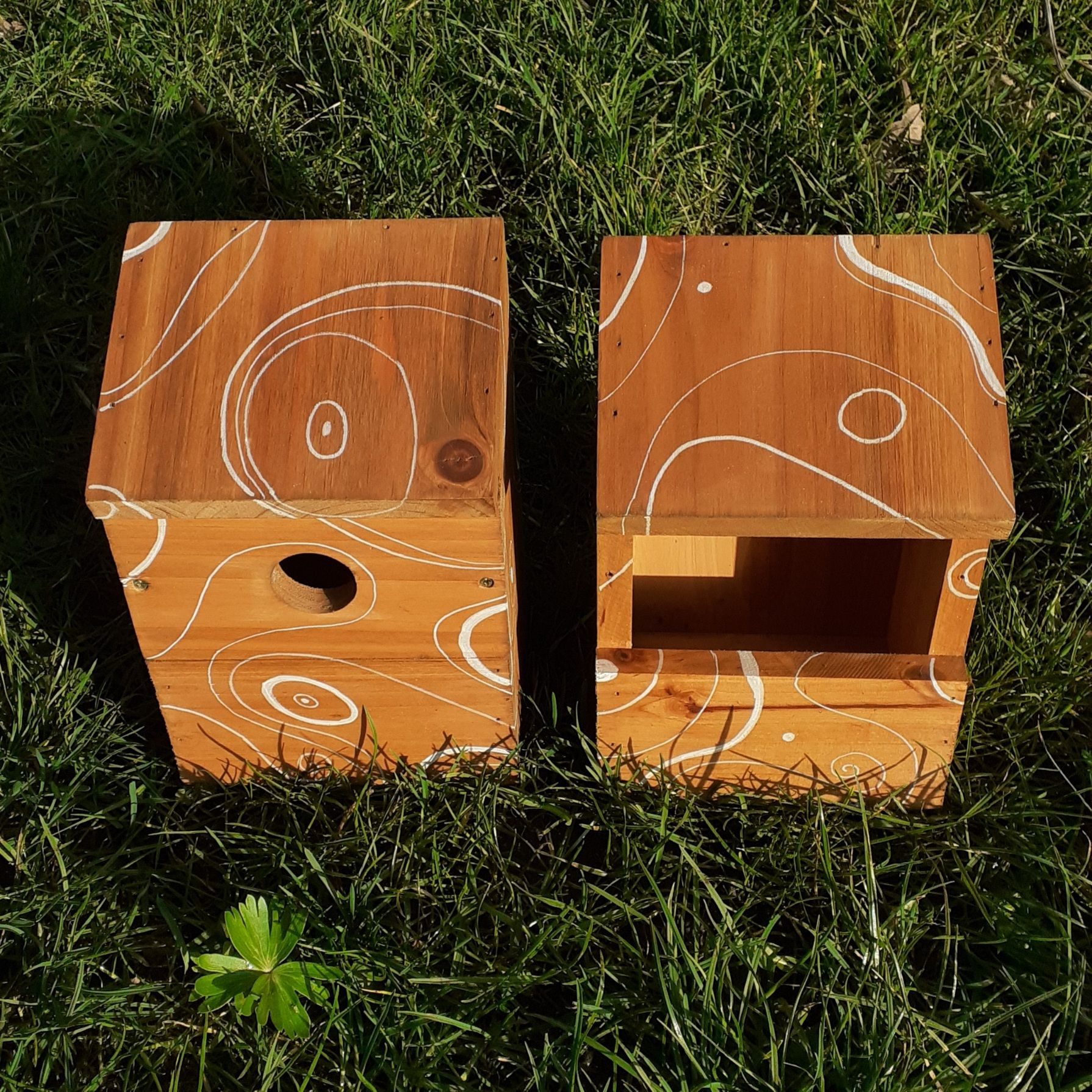 Photo of two nesting boxes decorated with white topographic lines