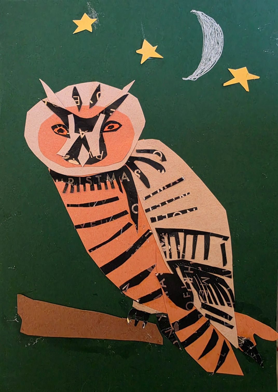An owl sits on a branch on a dark green background with a moon and three stars behind