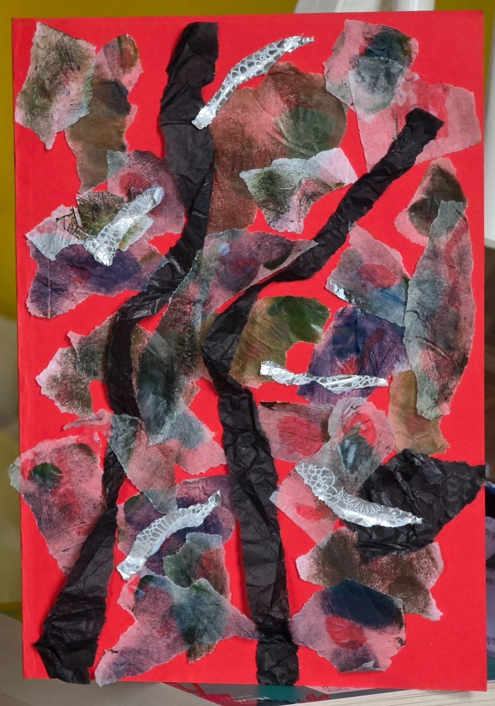 Red background with two black higglepigglety vertical lines. Blobs of semi translucent colour