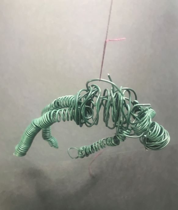 wire figure hanging on thread