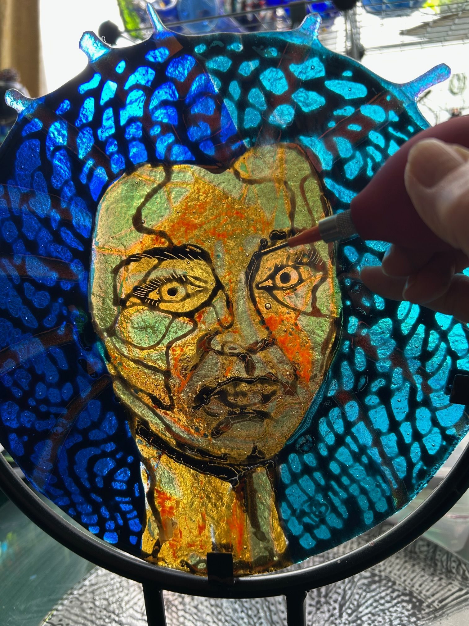 Picture of a woman's head and the black lines made by drawing ink lines on glass