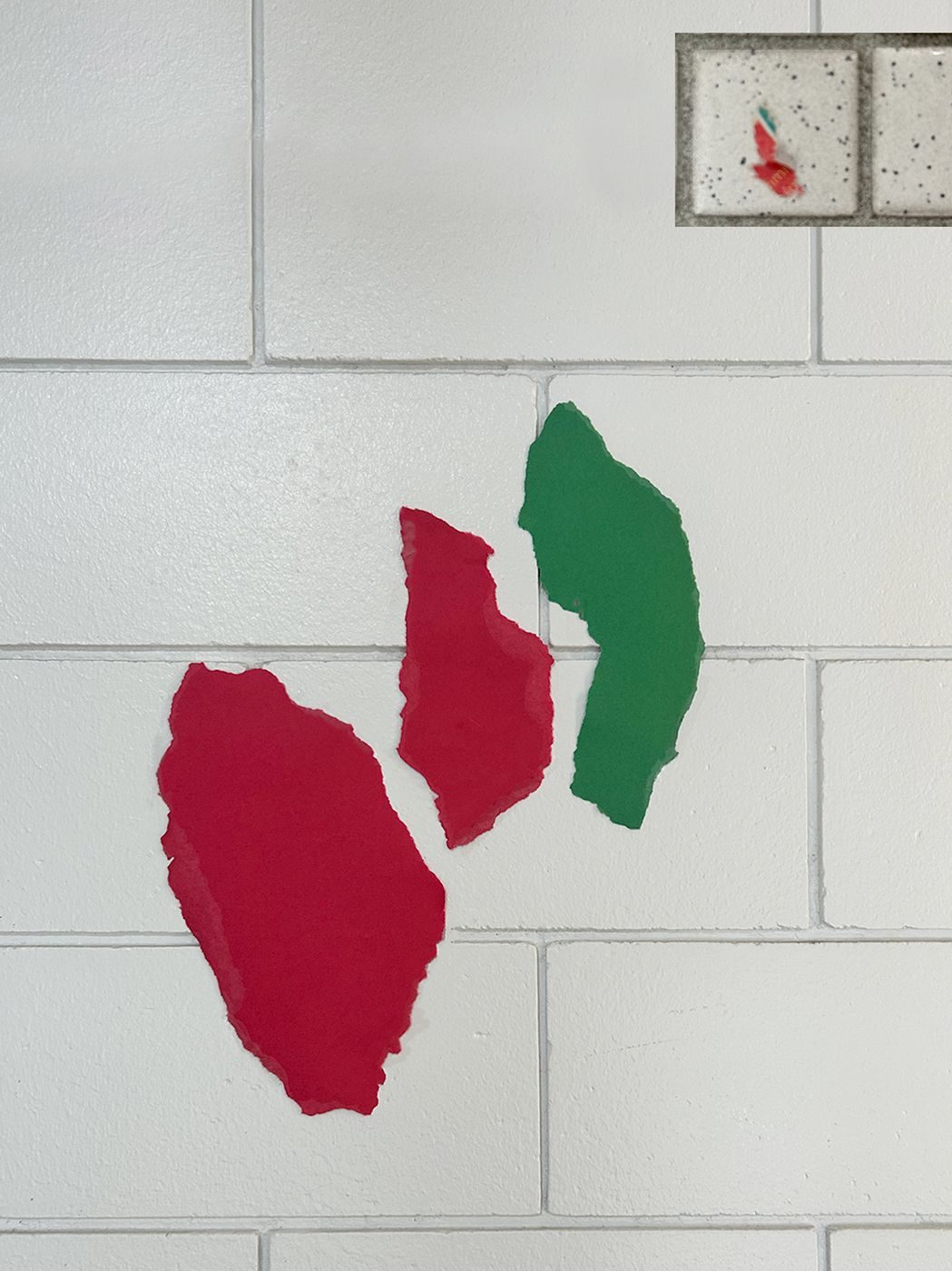 image of ripped red and green paper with a reference photo on the top right side