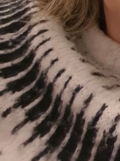 section of fairisle jumper and grey hair
