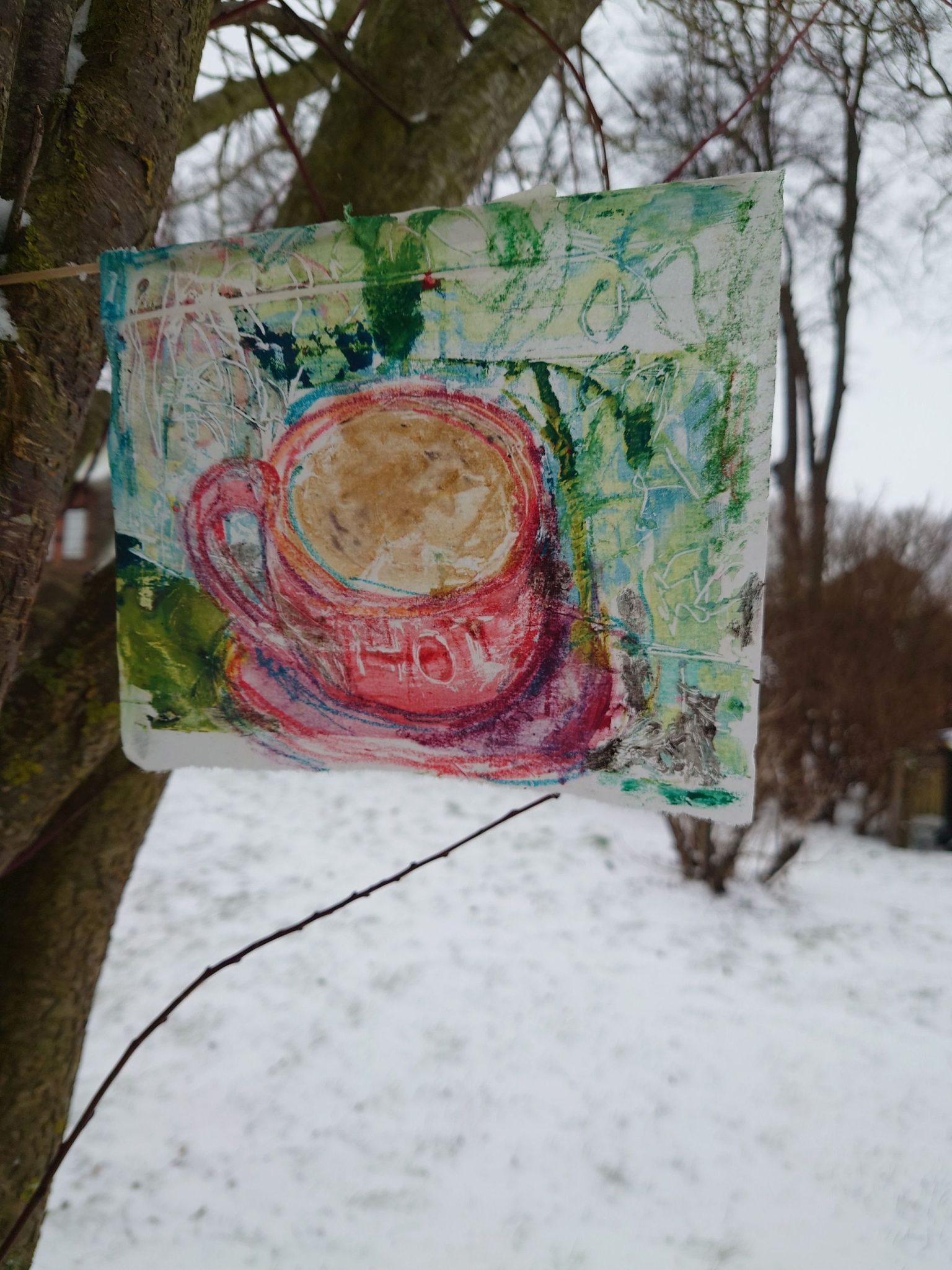 Paper flag advertising a hot drink in a snowy landscape