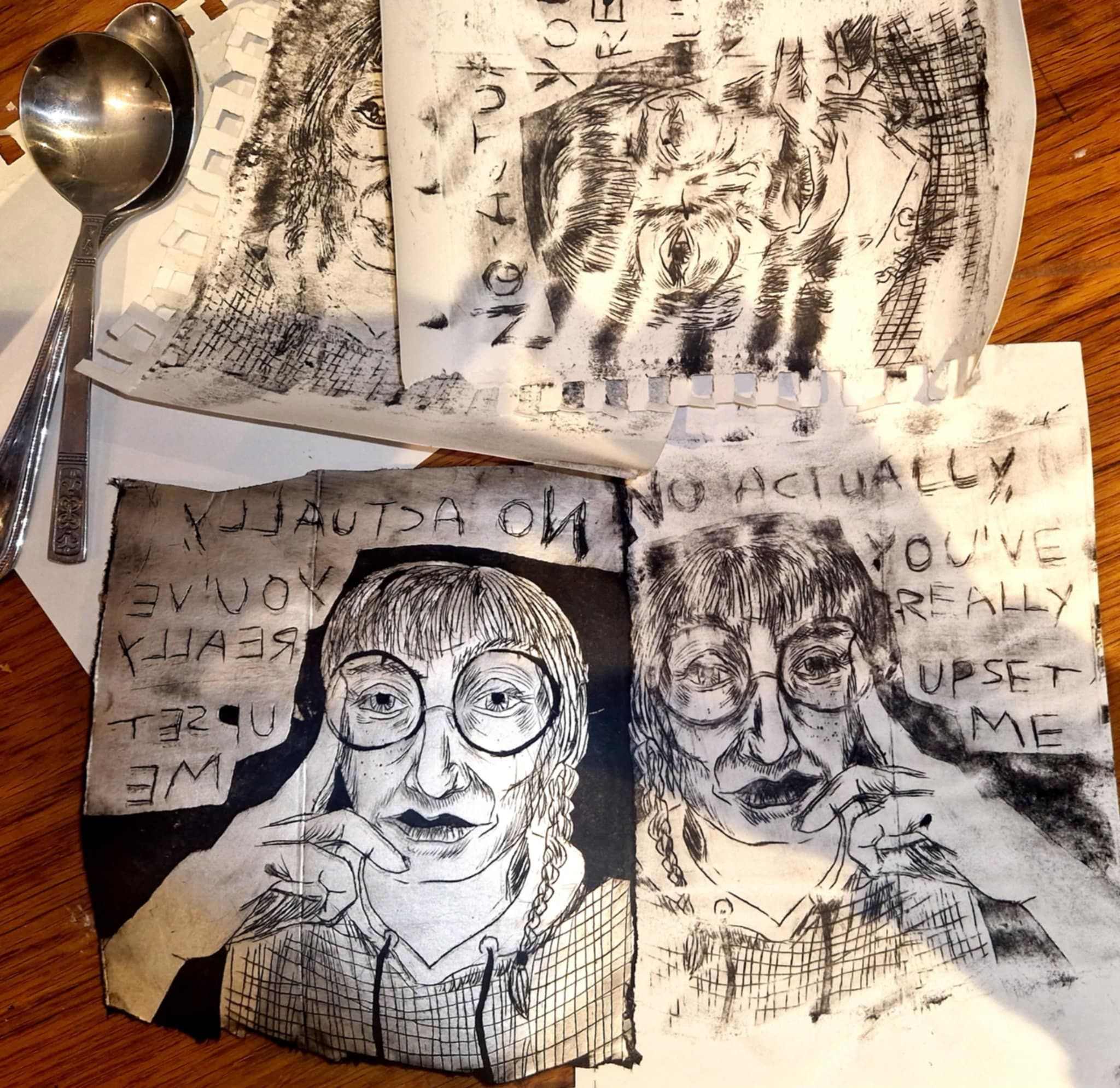 a negative and 3 ptints in black and white of a girl in glasses with her had to ger face looking sad, the text on the print says 