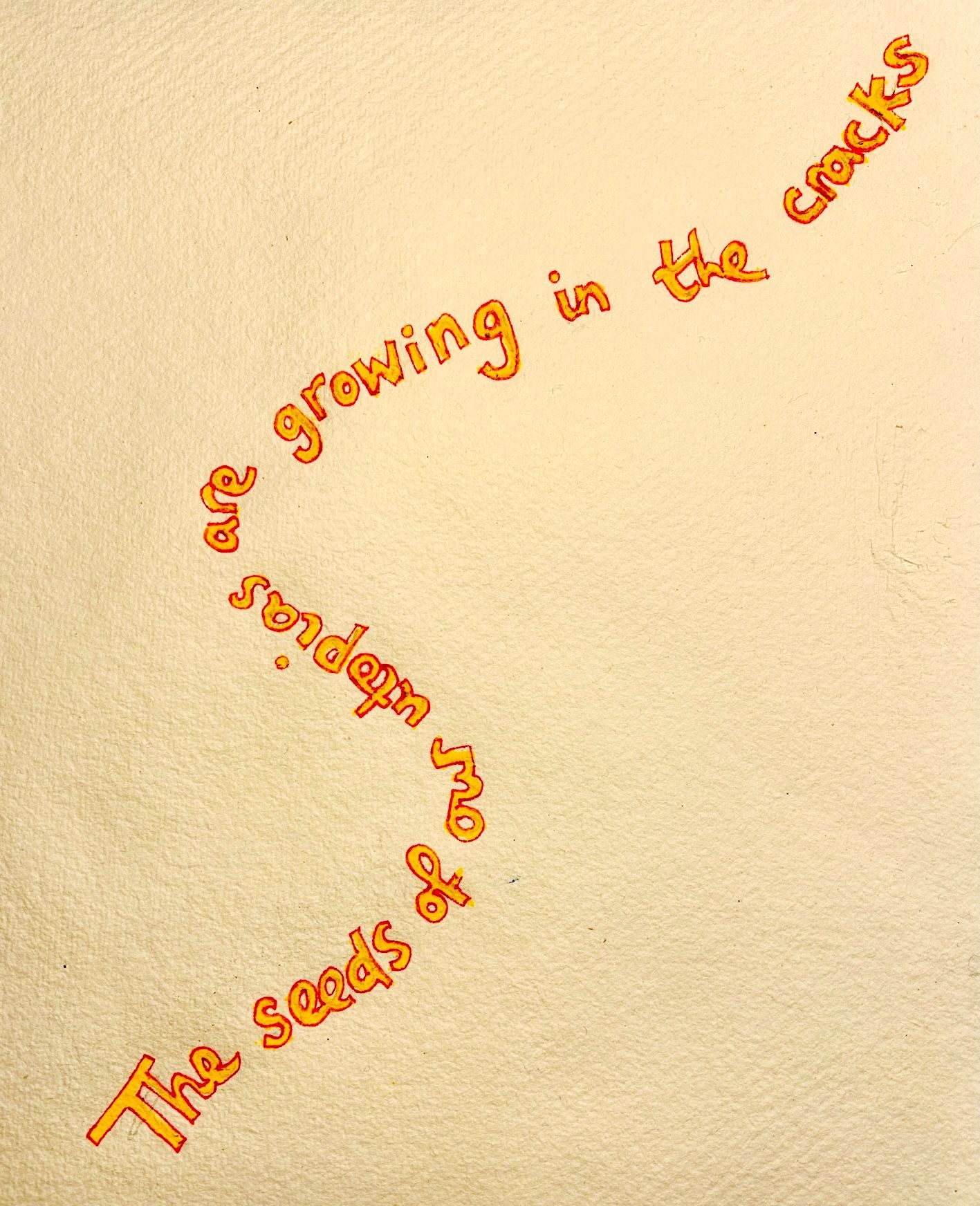 Yellow writing outlined in red growing up the page, that says 