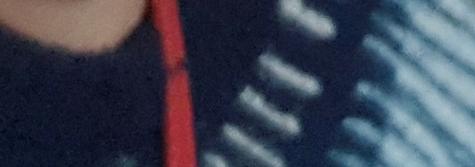 blurred section of fairisle jumper and red bag strap