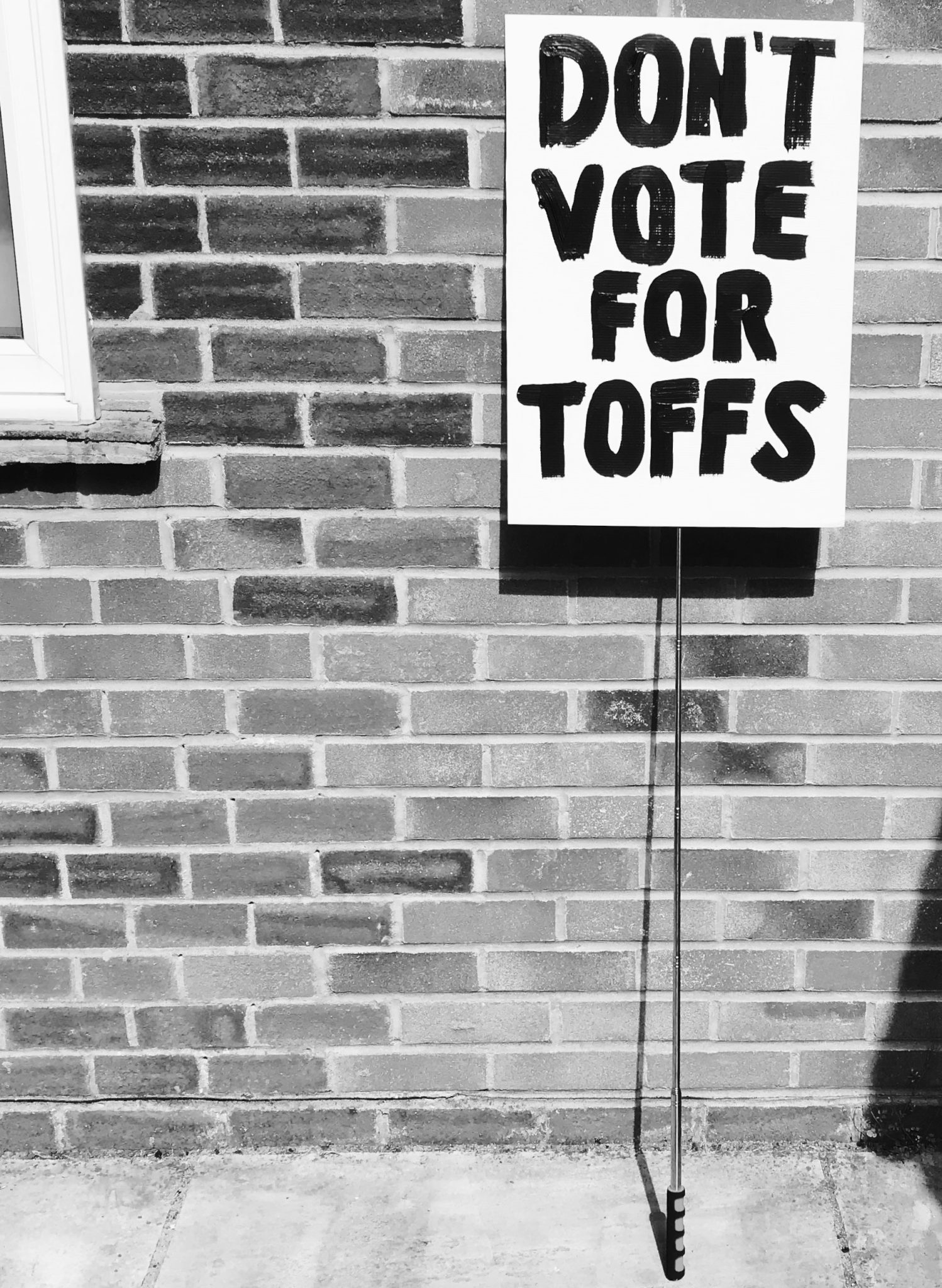 A large placard attached to a pole with 