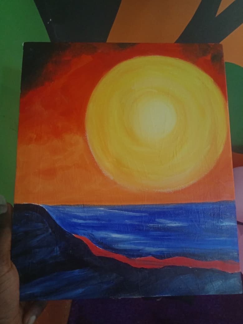 It’s a painting of the sunset beside the ocean side vibrant in bold colors of orange  and yellow,red for the deepest part of the sky and blue waves on the water in the ocean