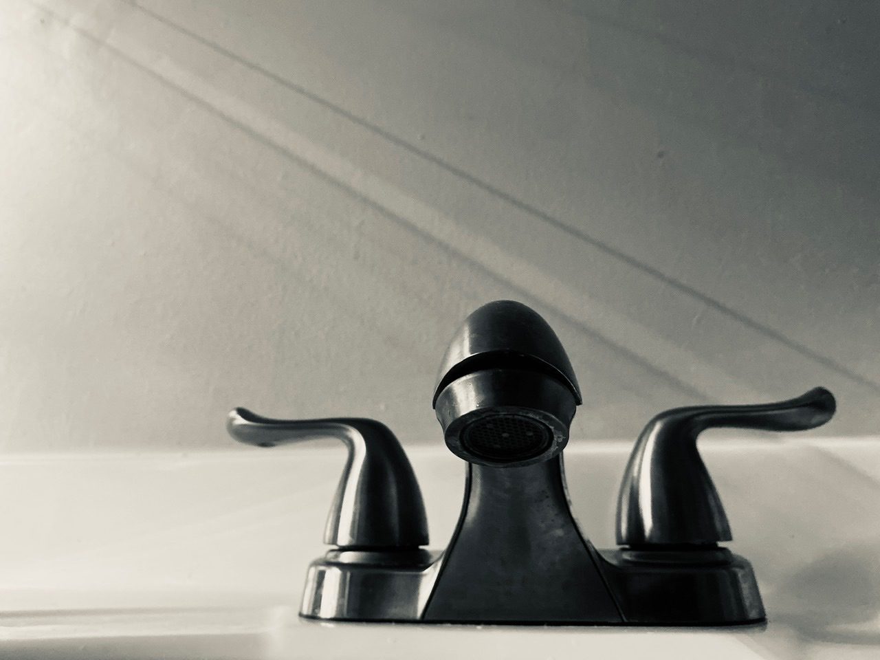 Monotone Photograph of a Tap and Light
