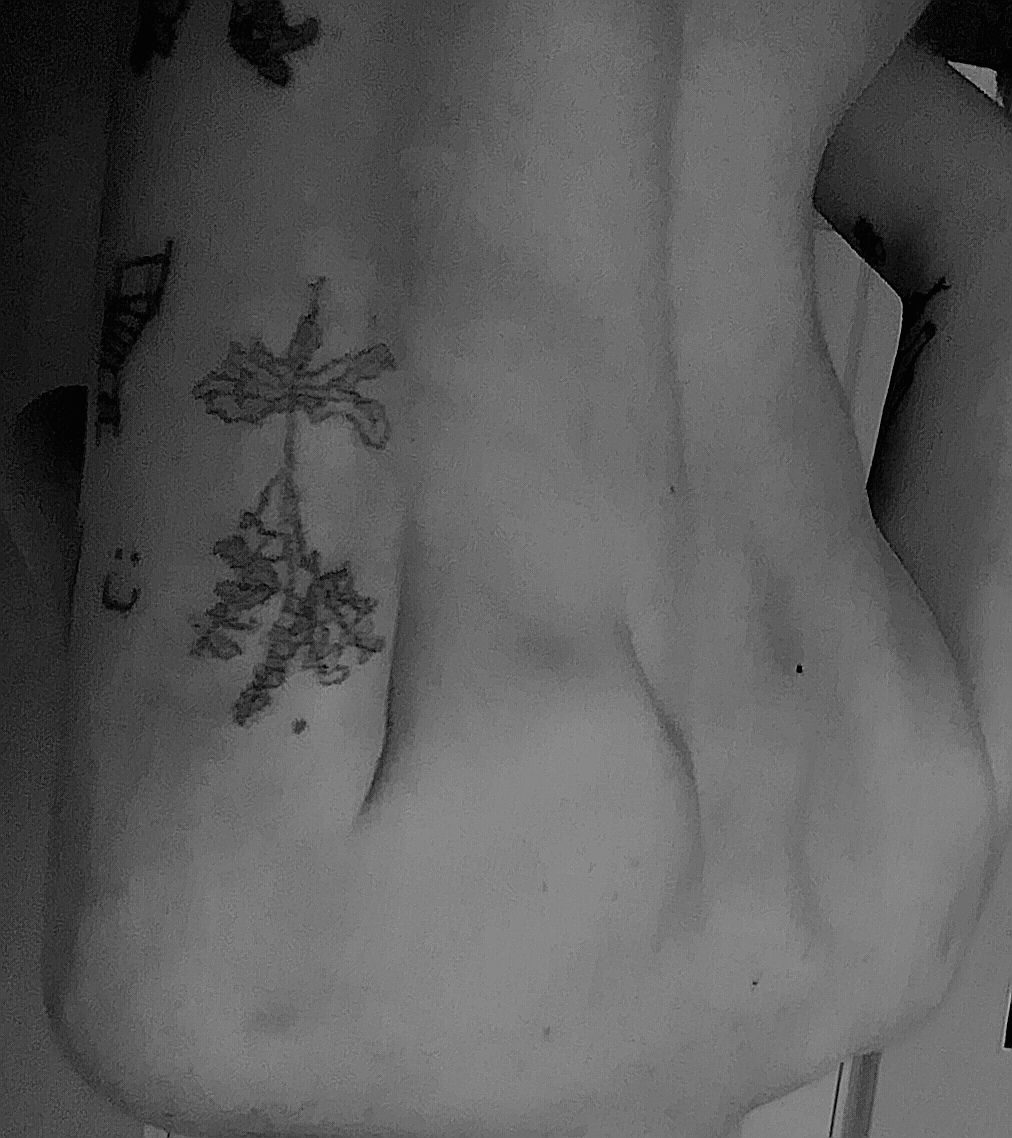 Black and white photograph image of the artists back, cropped and positioned upside down