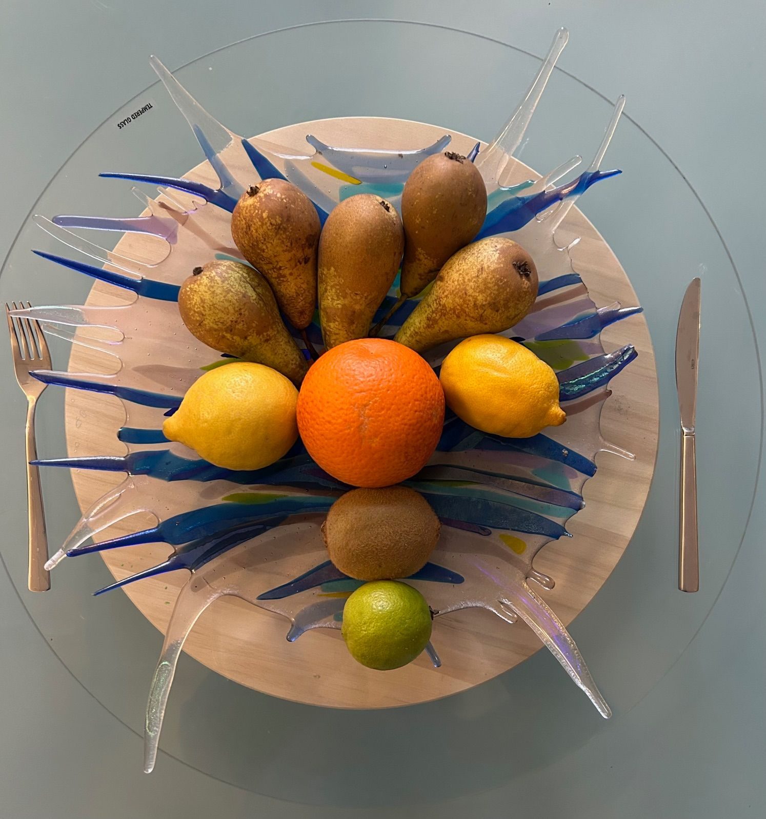 Fused glass plate with fruit and cutlery doubling as lunchtime