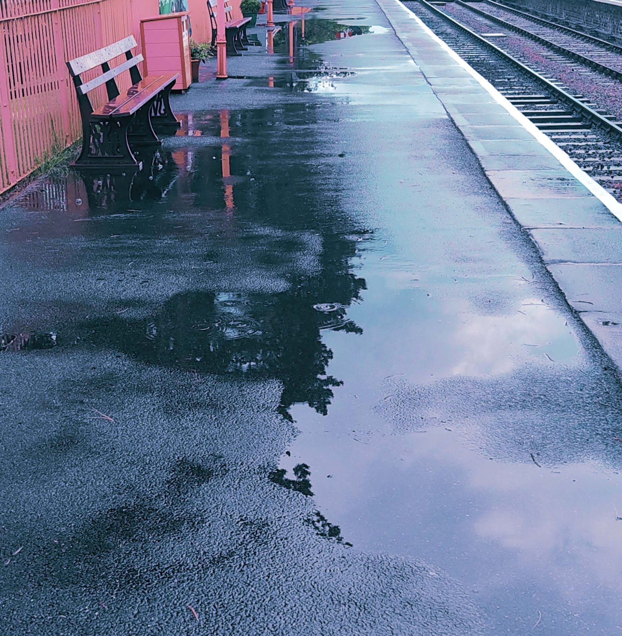 benches and puddles at a railway station