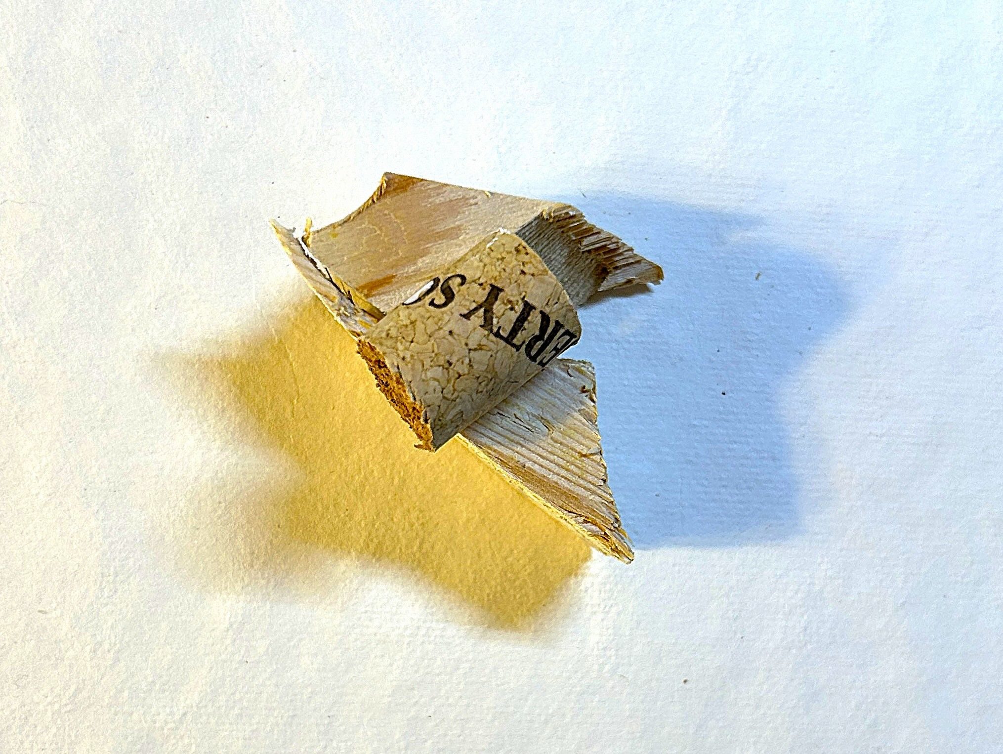 two small pieces of wood with a cork balanced on the top