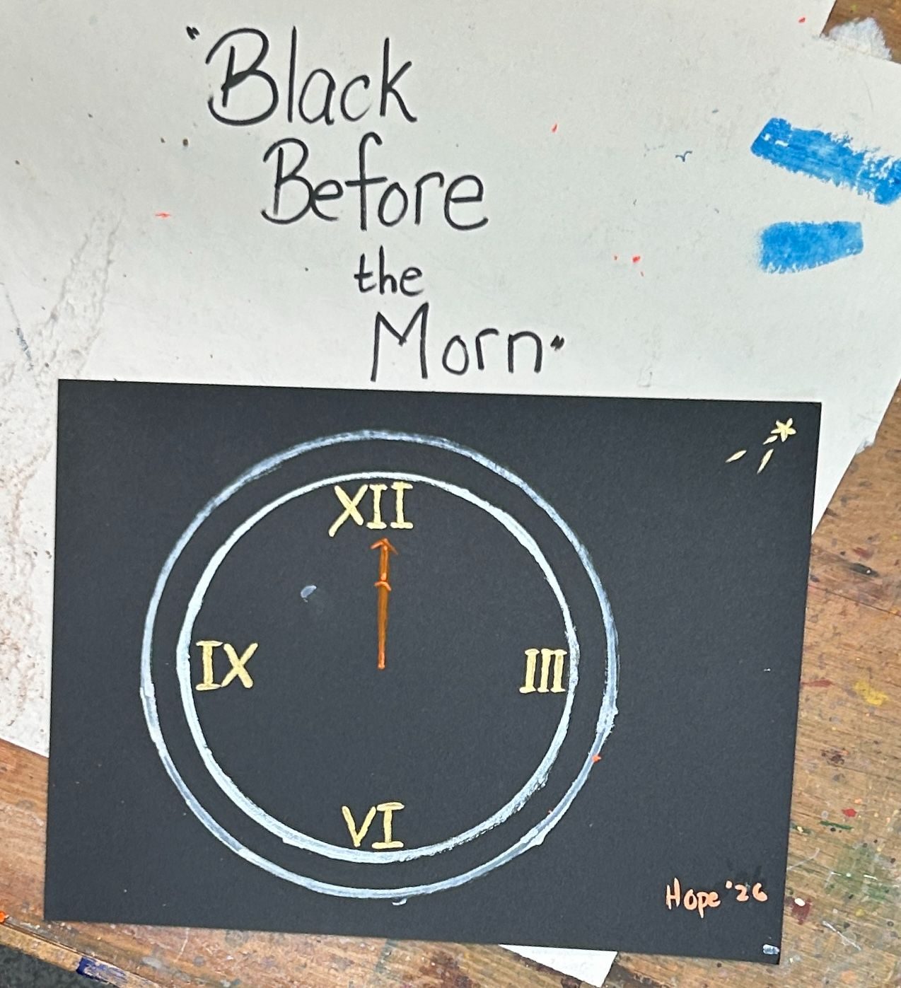 a clock face painted on black paper