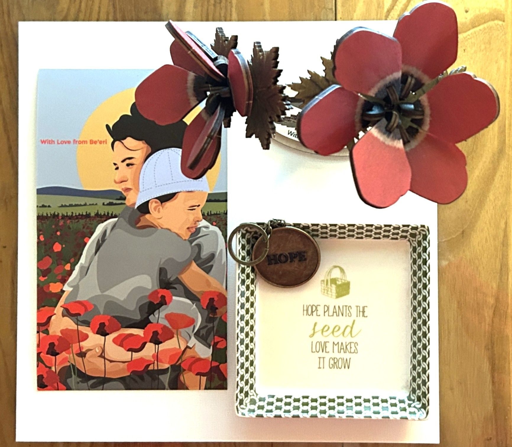 A wooden red flower, a Hope key chain and a Plant a Seed dish