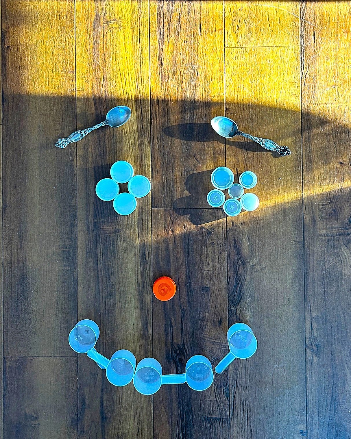 Using kitchen items, I created a smiley face on the floor