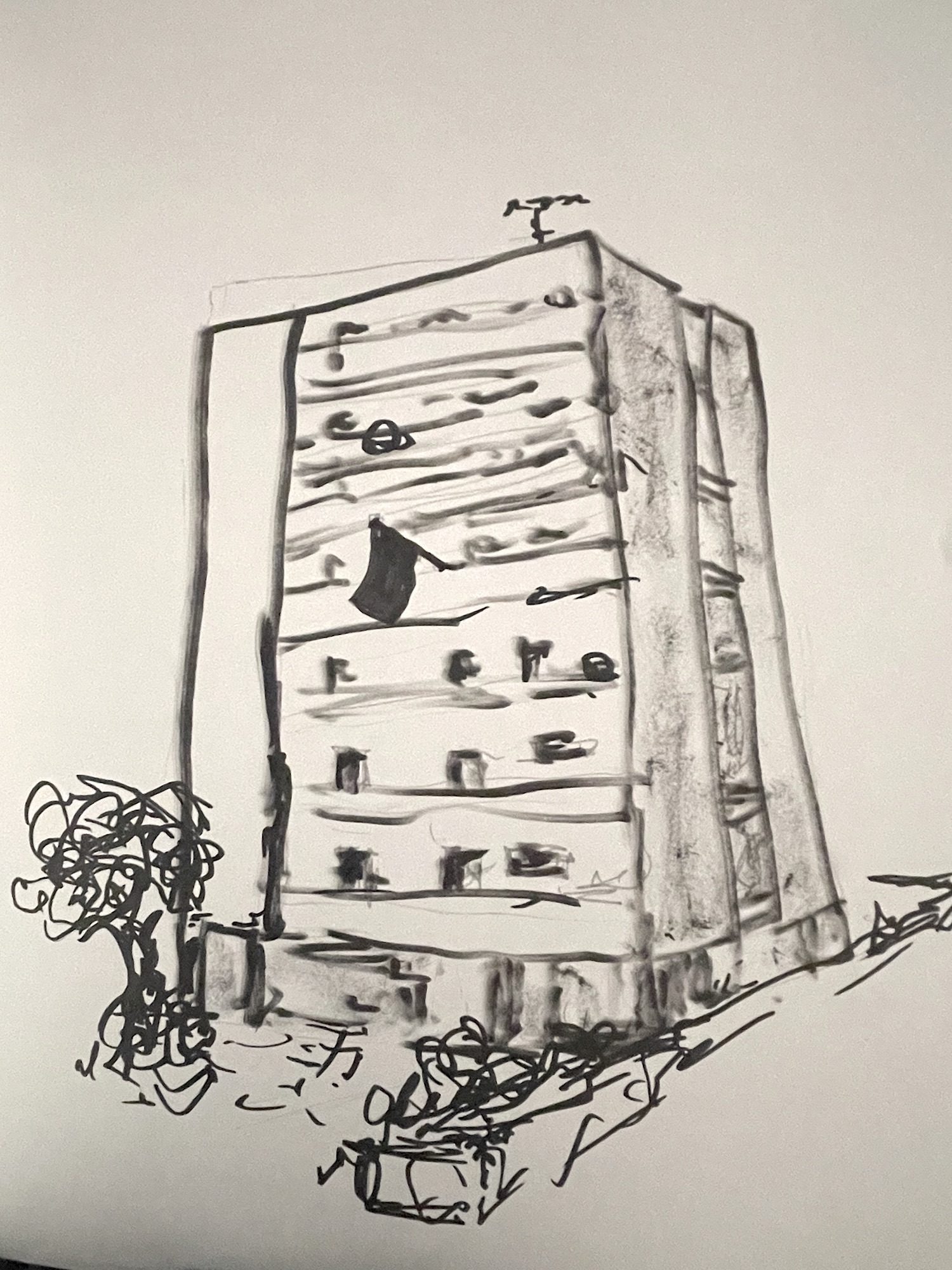 A drawing sketch of a tower block, with some trees and bushes around.  From one of the balconies a black flag is flying