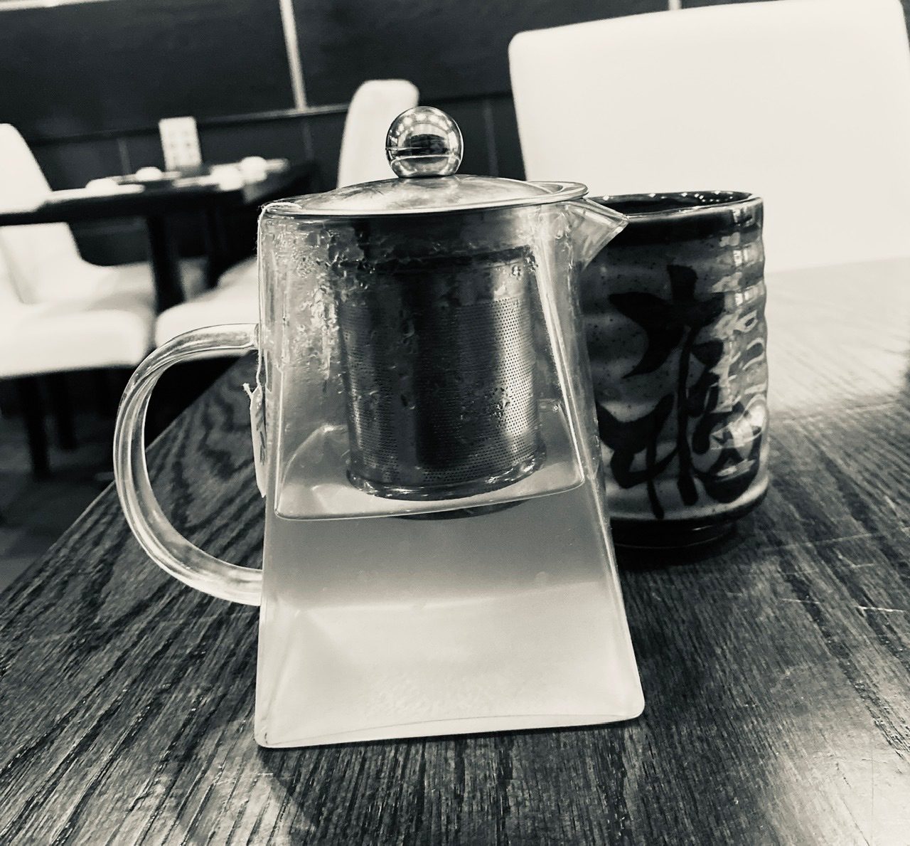 Monochrome photograph of a tea pot and cup