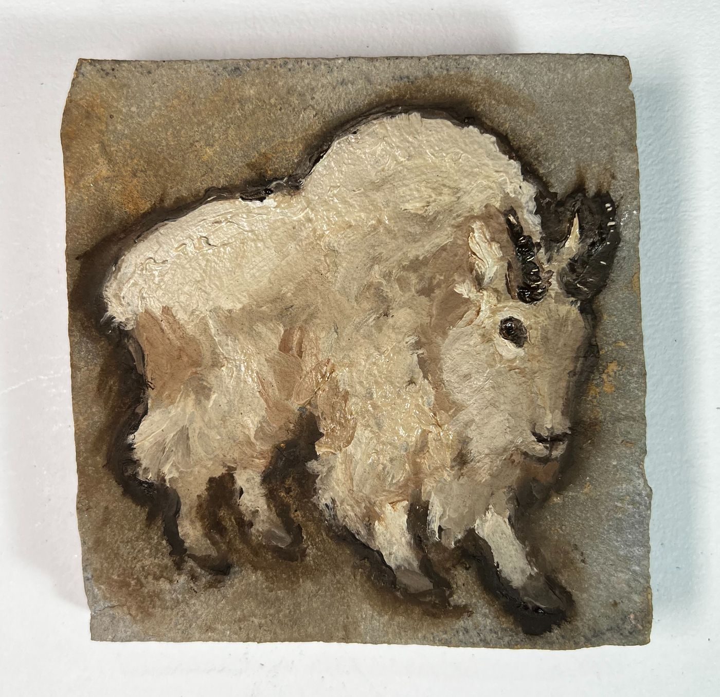 Oil painting of a cream mountain goat on sandstone