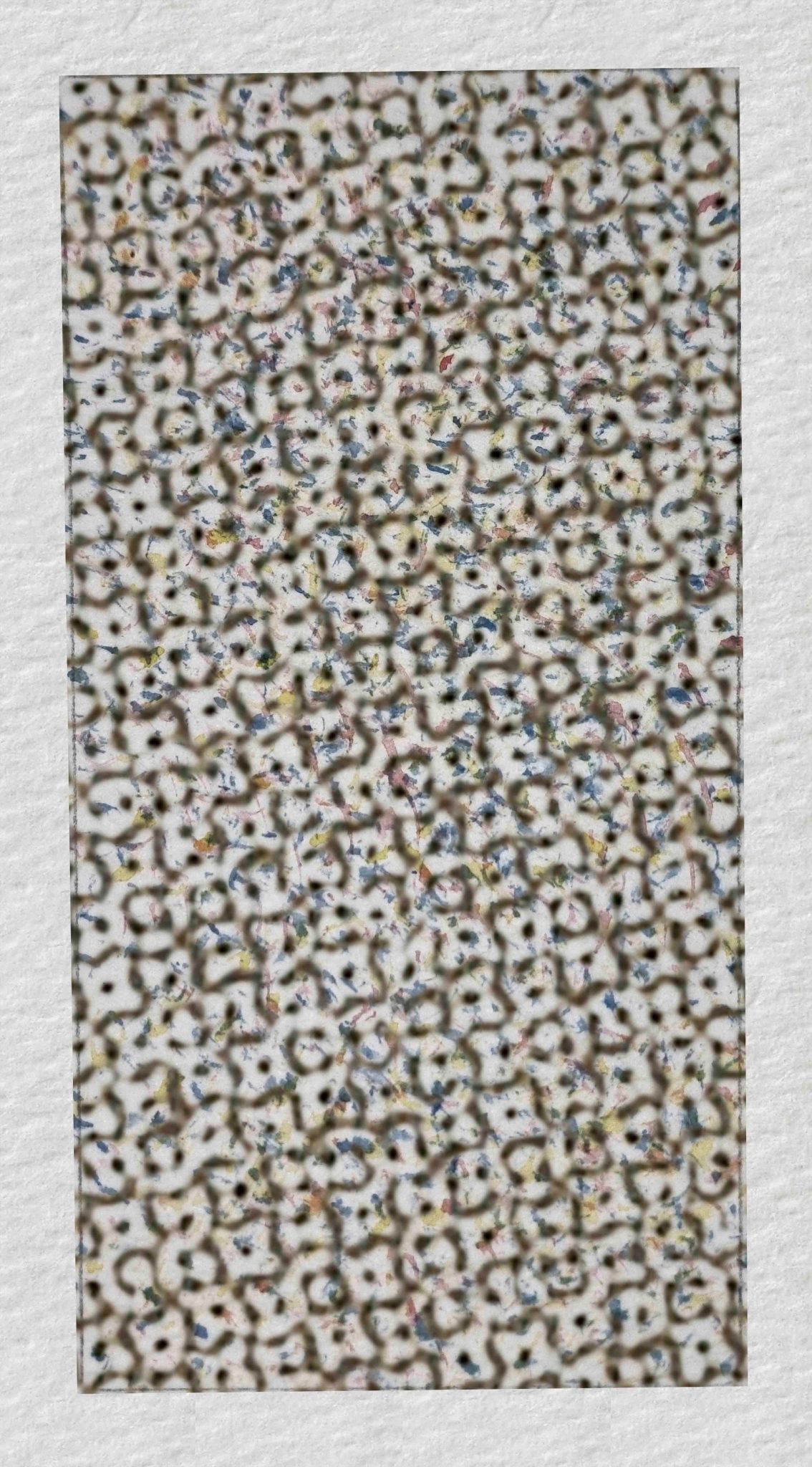 Portrait format 1 by 2 proportion. White paper frame around textured ground, grey with flecks of yellow, red and blue.