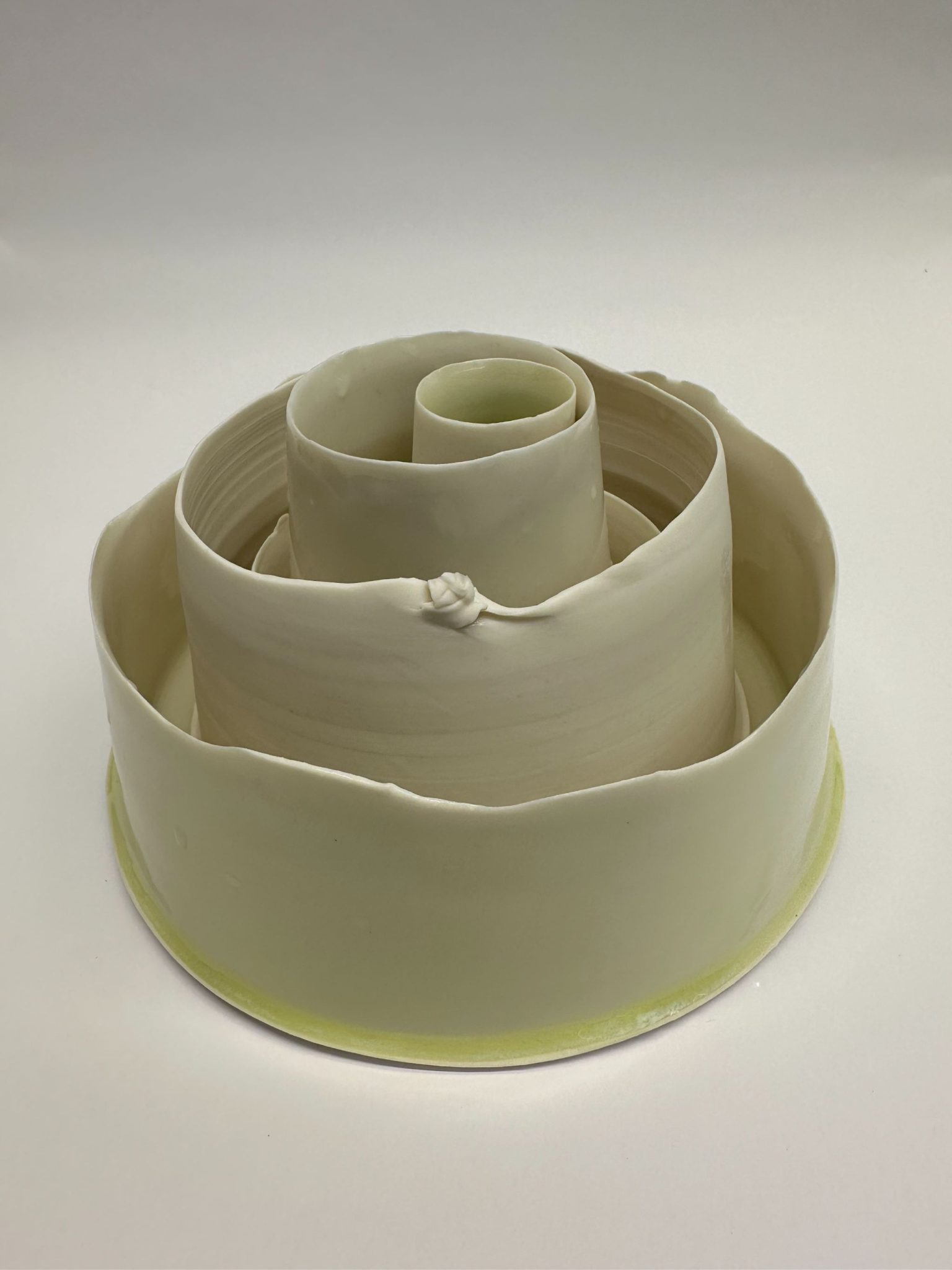 Set of porcelain vessels with pale green glaze stacked inside one another