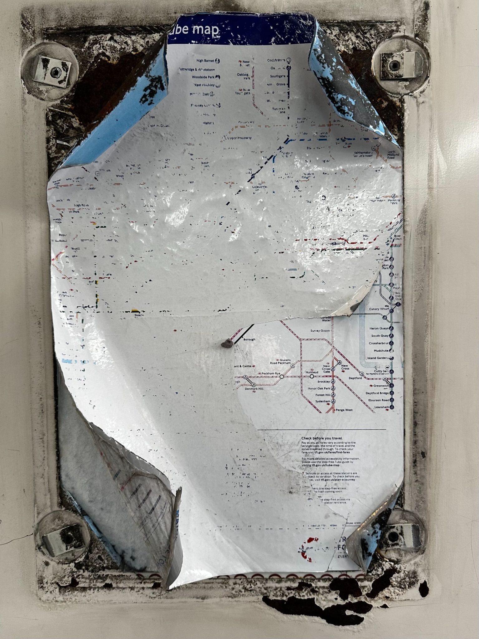 Photograph of old, faded and peeling tube map on the train carriage on Bakerloo Line train