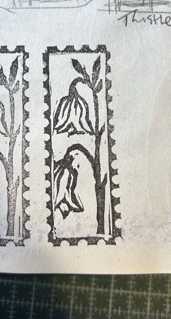 A mini lino print of bluebells with a stamp border