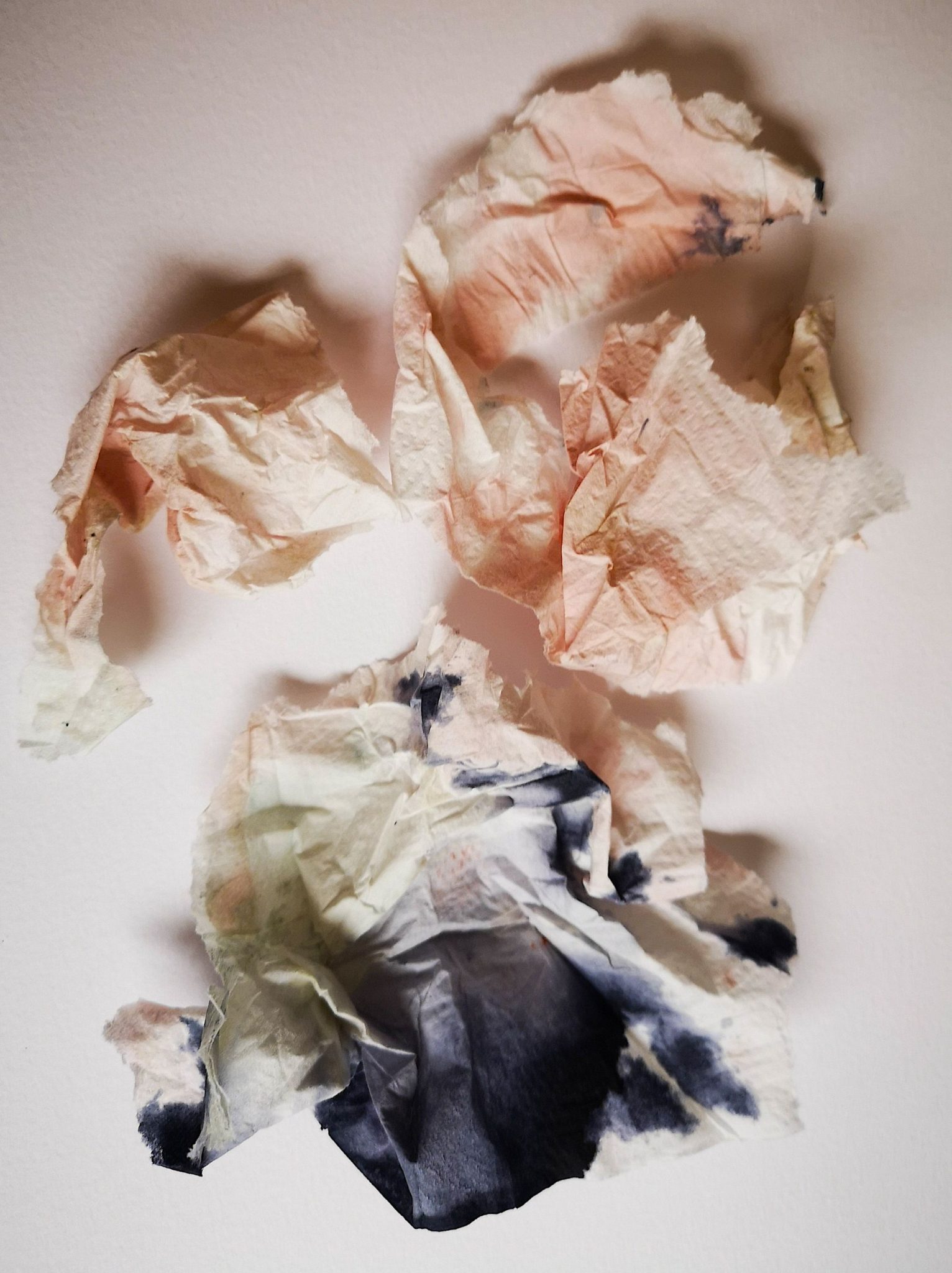 a collage of tissue paper with ink - creating an image with eyes closed shut