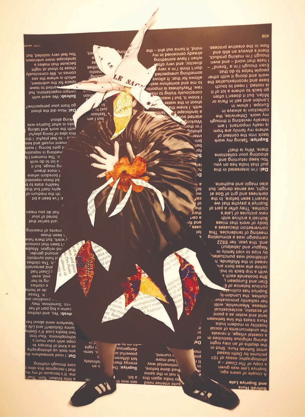 This collage of a figure has a moon face with collage flowers on her skirt, preparing for upcoming spring!