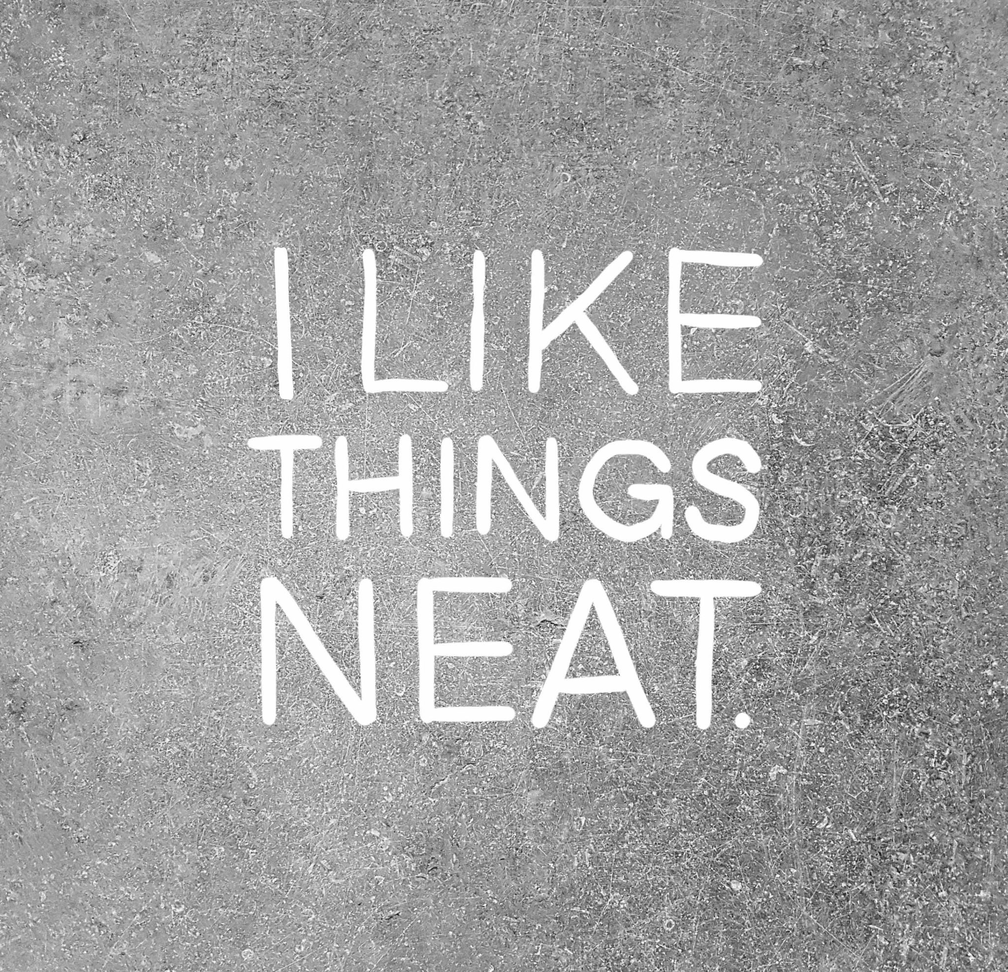 Dust rubbed away spelling out the words I like things neat.