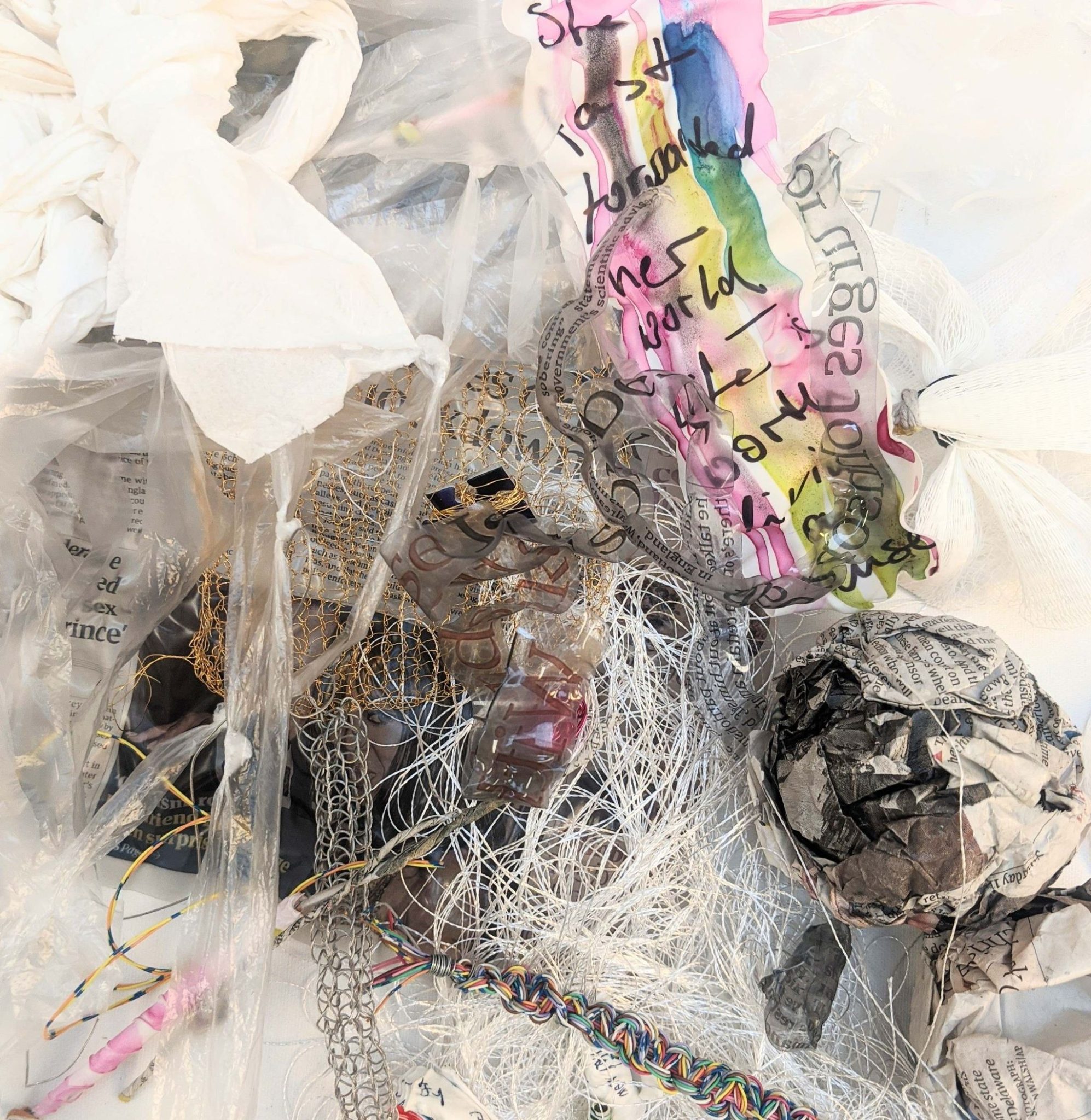 Assemblage of bits and pieces, knitted wire, ball of tangled thread (done by the dog), newspaper, melted plastic sheets and acetate, strips of cling foil and wiring.. All artfully arranged:-)