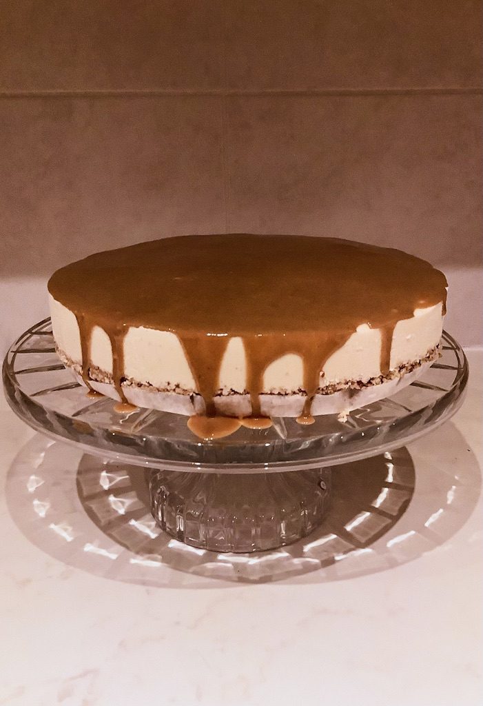 A photo of a cheesecake on a cake stand