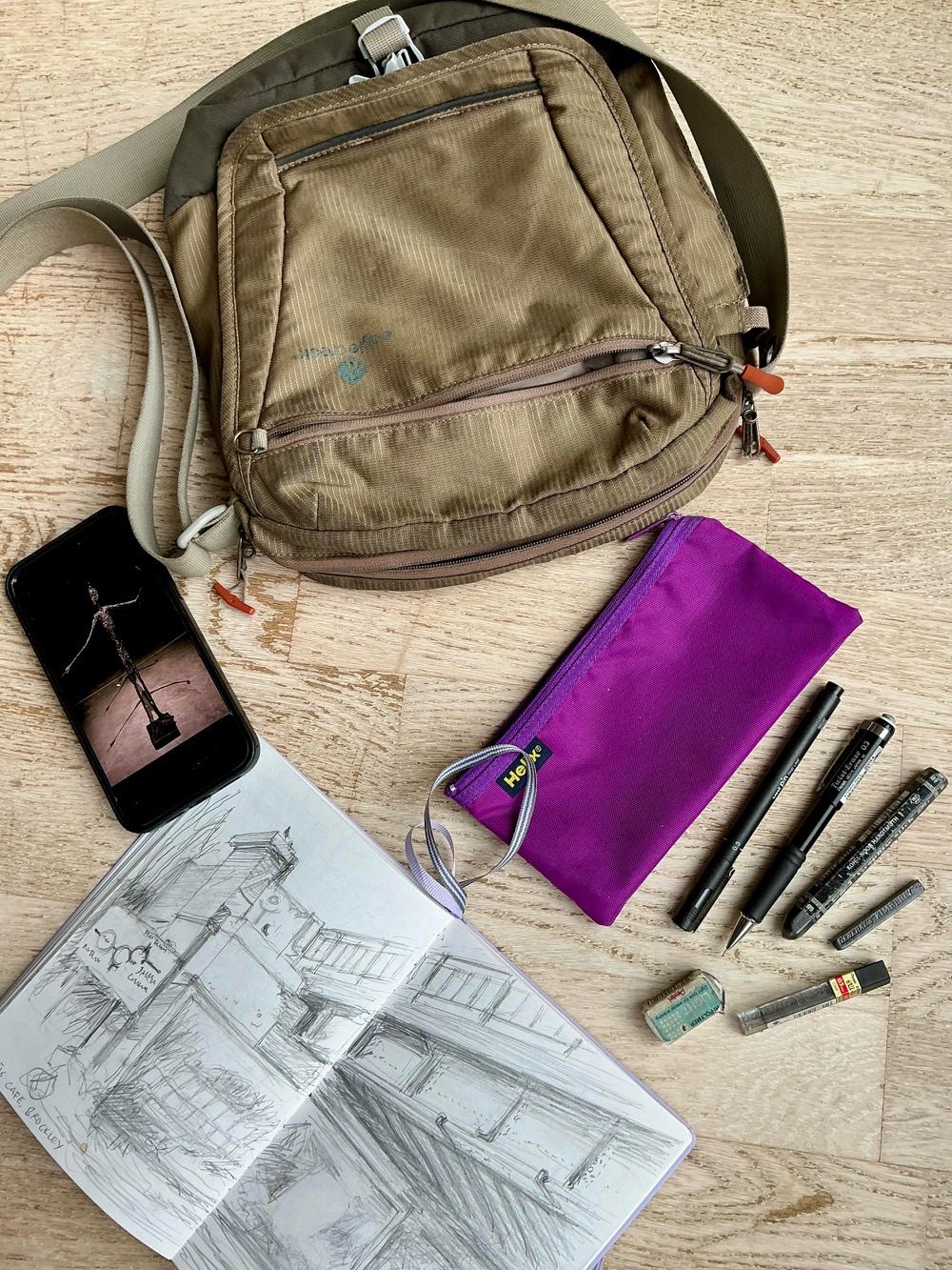 Photograph of everyday art set, iPhone and bag