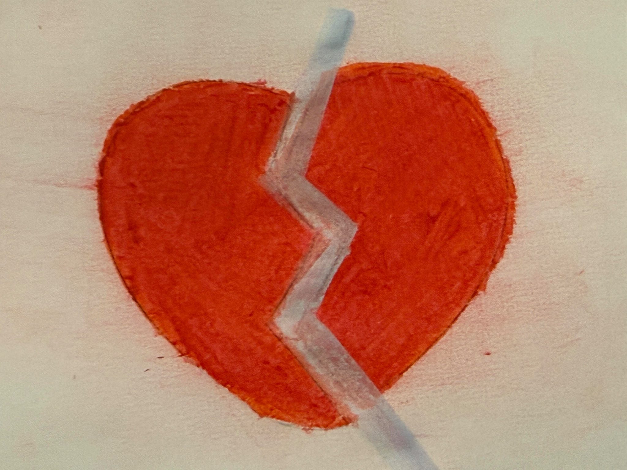 A broken heart mended in the middle by a white/blue zigzag.