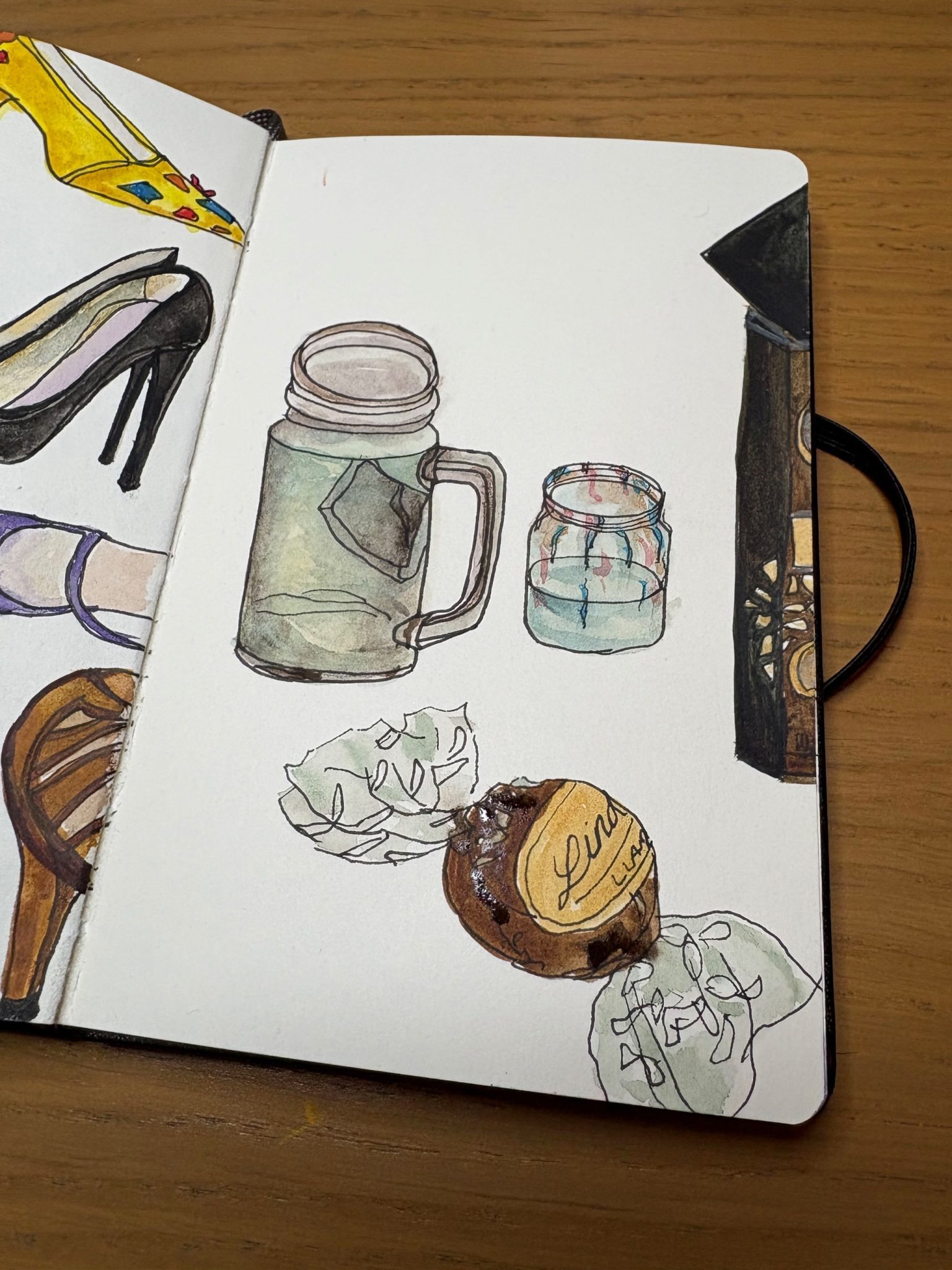 Watercolour painting of a glass cup, jar of water, box of chocolates and single chocolate