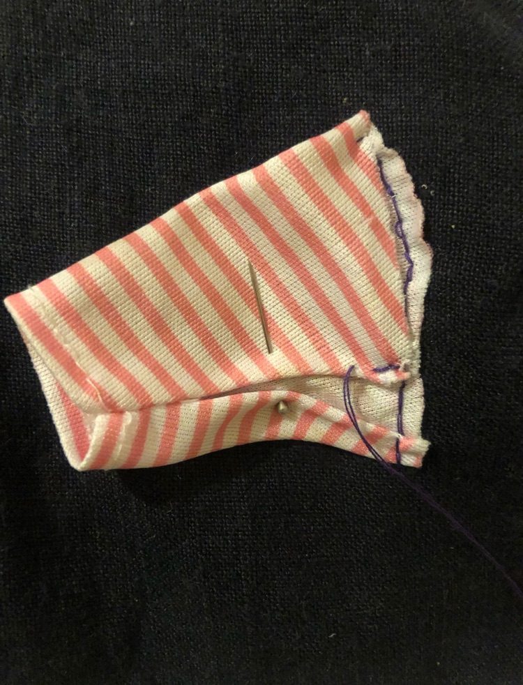 a found object- jumper for a baby doll that was unpicked, separated and stitched randomly. This sleeve, pinned at the time and stitched onto a free fabric sample claimed from sofa/curtain companies or similar.