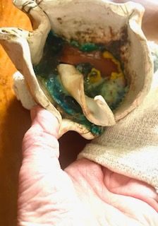 my hand bandaged wrapped seeking to feel the ceramic work I hold