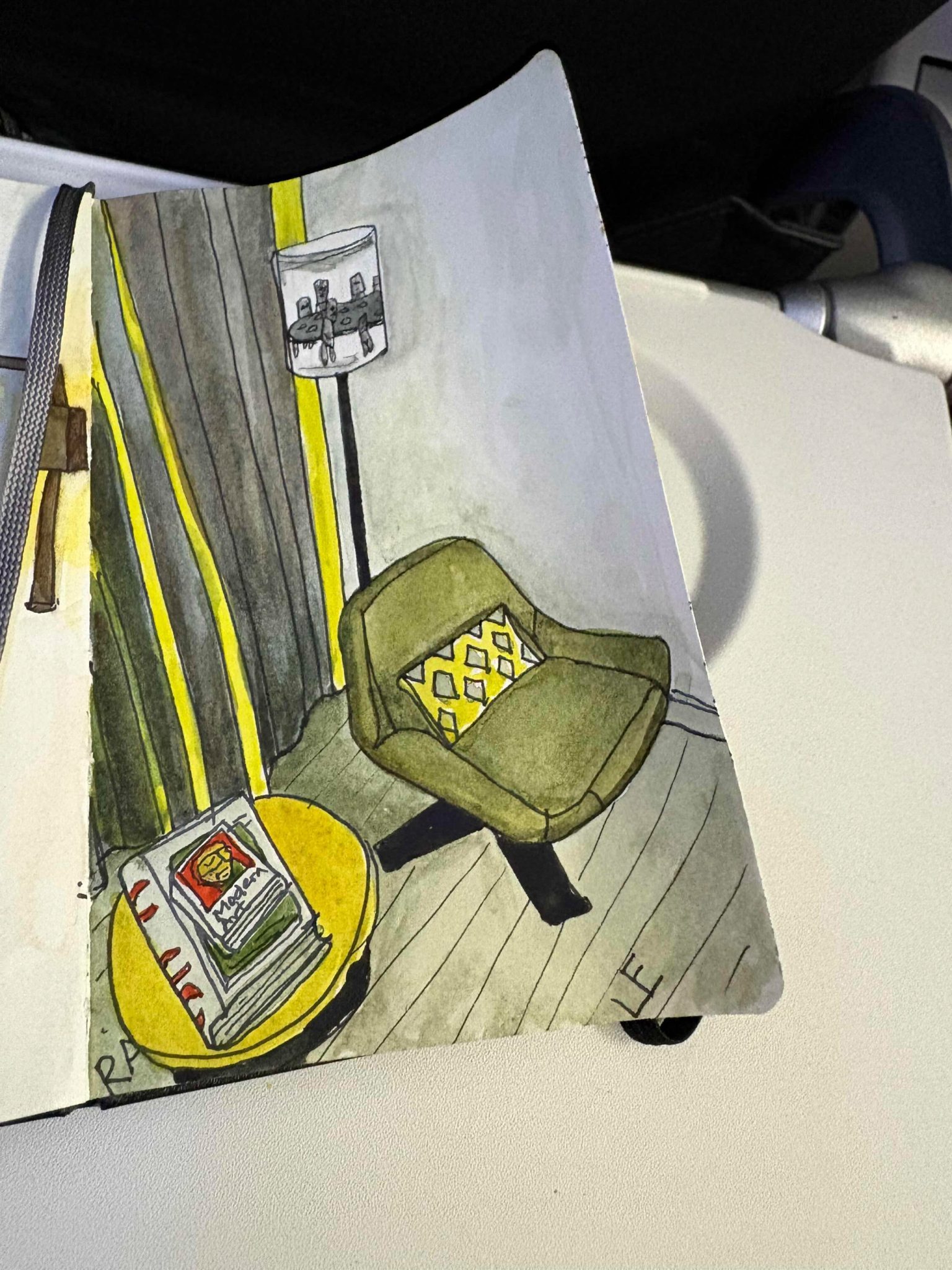 Watercolour sketch of a chair, lamp, curtain, coffee table and books