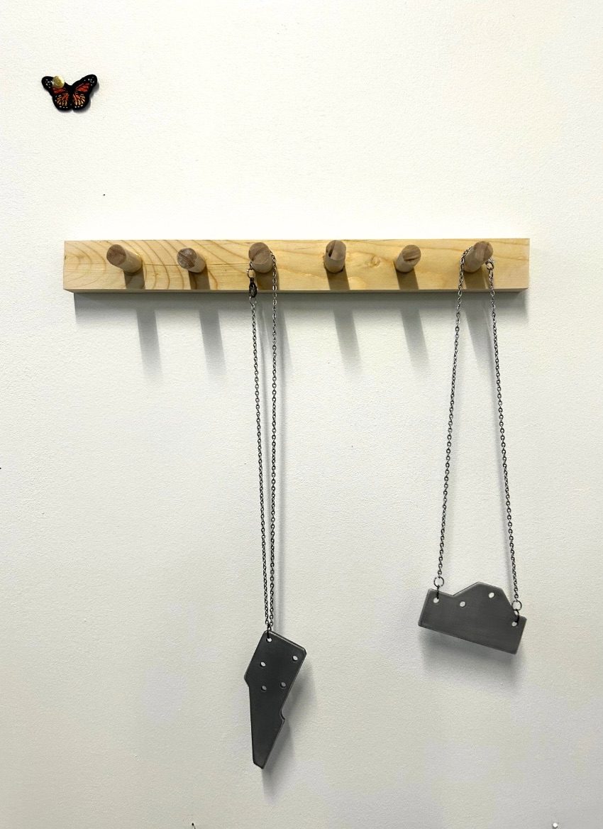 Image of wooden necklace holder mounted on a