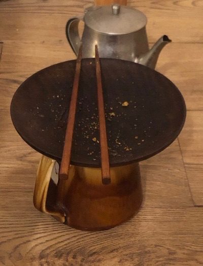 my favourite wooden chopsticks on top of round wood plate on top of a jug I’ve had for a long time. Behind is a metal tea pot once my parents- seeing the whole coincidental arrangement gave me great a moment of self congruence last month.