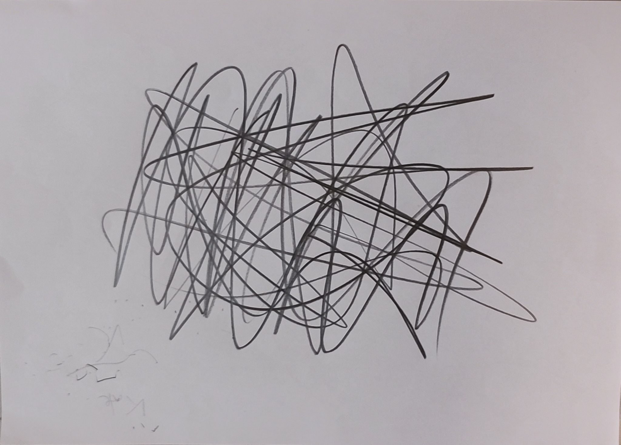 A scribble using 3B pencil in the centre of an A4 piece f computer paperof A4