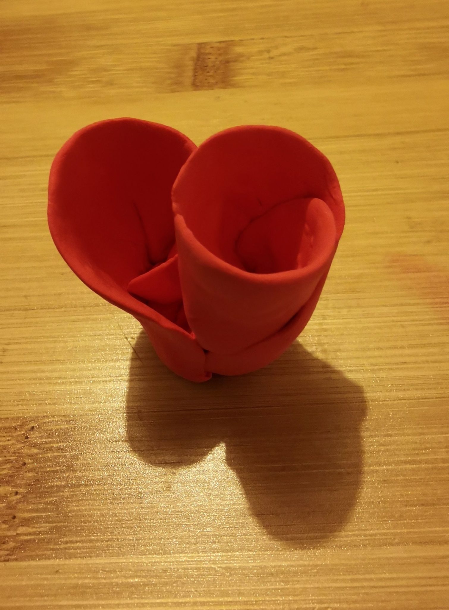 Hand thinned pink air drying clay, folded into shape. Created a standing vessel with two folder tubular openings. Small enough to hold.