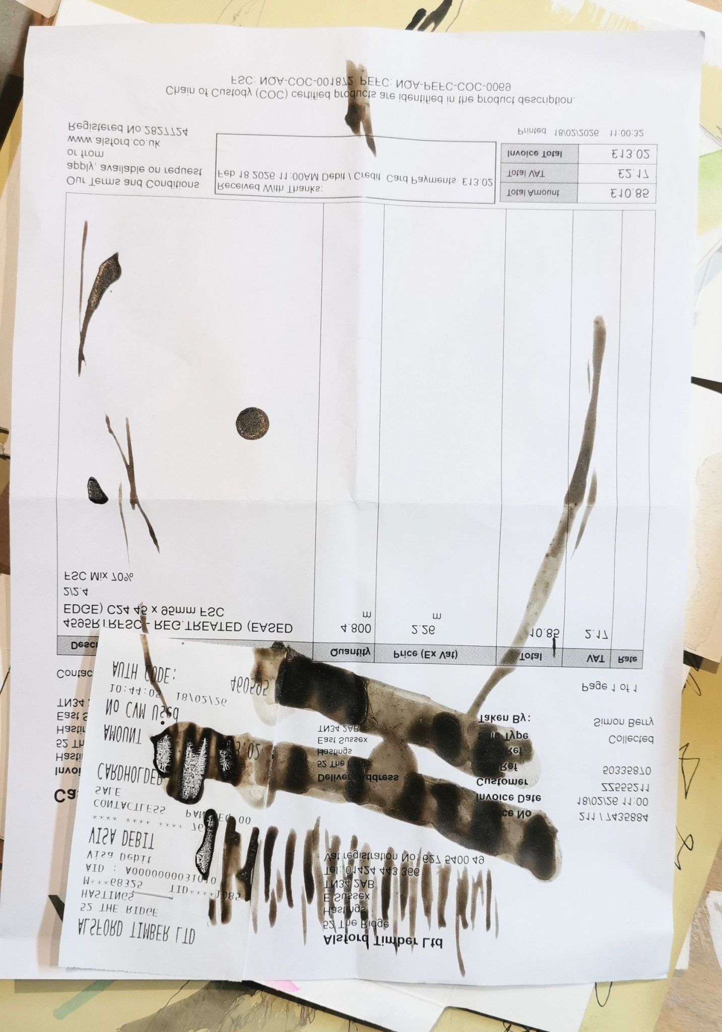Abstract ink drawing on paper invoice and stapled on receipt