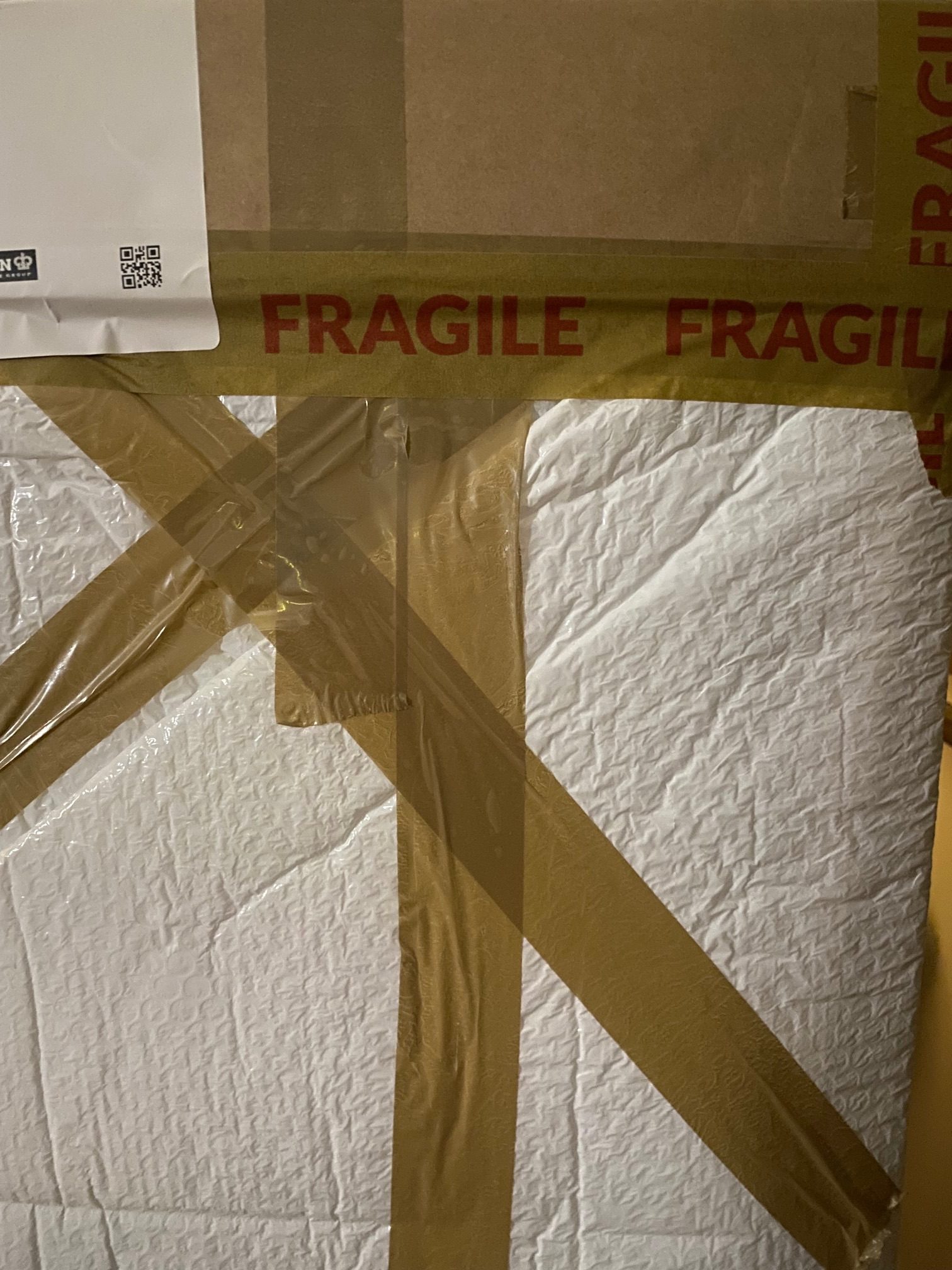 Photograph, box covered with packing material and ‘fragile’ tape