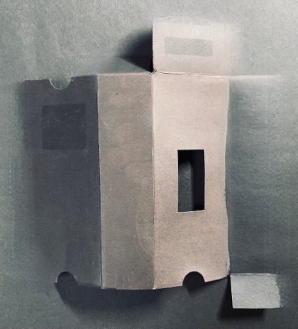 Highly edited photograph of flat thin sun-bleached cardboard packaging