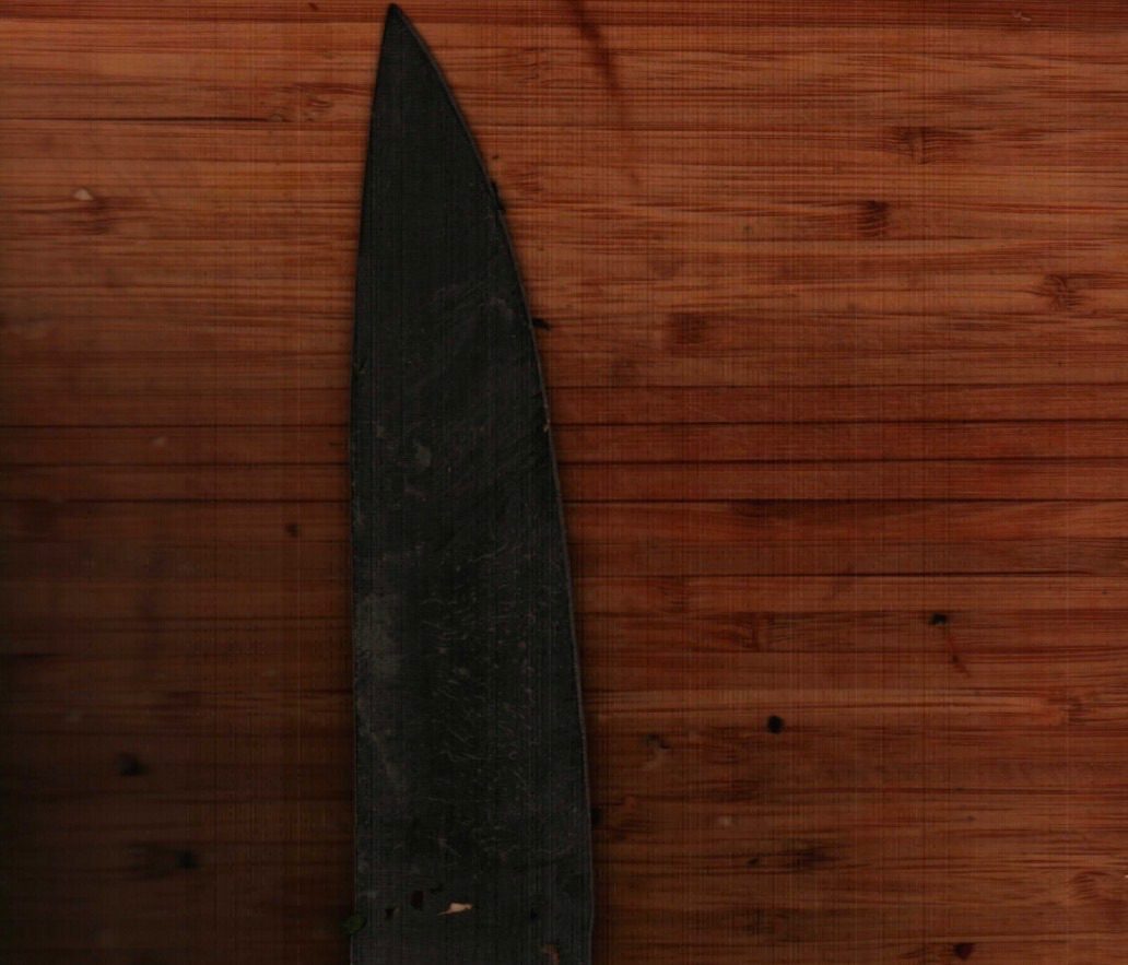 A scan of a dirty knife on a board