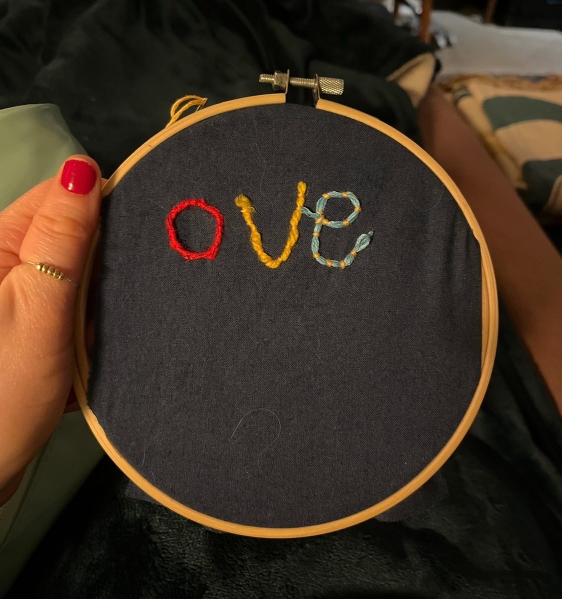 The letters “ove” stitched onto navy fabric